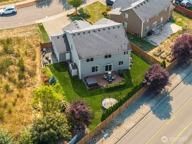 an aerial view of a house with garden space and a patio