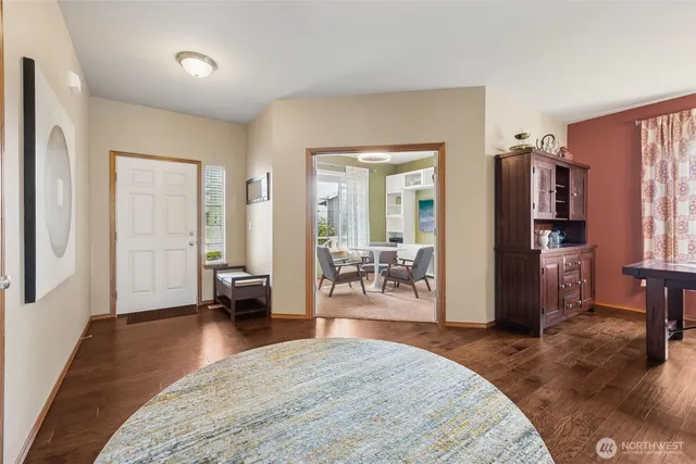 a bedroom with furniture and a wooden floor