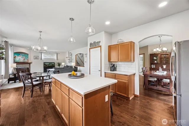 a kitchen with a sink a counter top space and stainless steel appliances