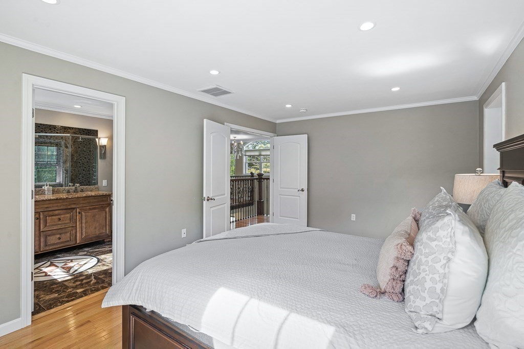 146 Ridge Street Winchester, MA 01890 - Photo 16 of 40 a bedroom with a large bed and wooden floor