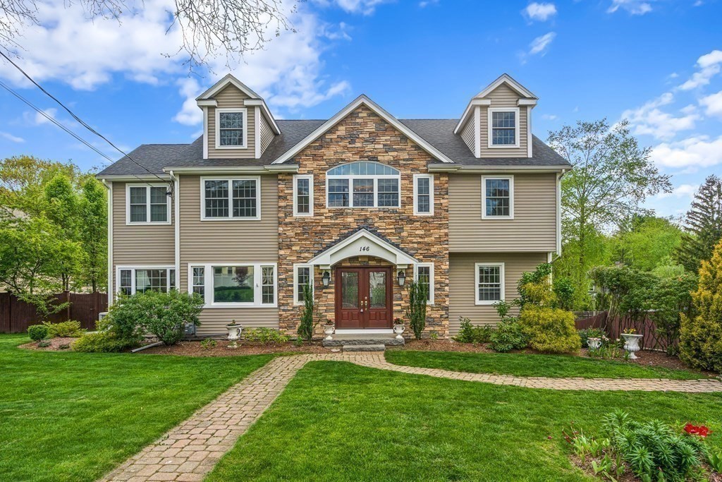 146 Ridge Street Winchester, MA 01890 - Photo 2 of 40 a front view of a house with a garden