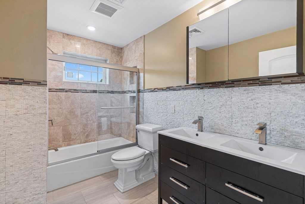146 Ridge Street Winchester, MA 01890 - Photo 23 of 40 a bathroom with a sink a toilet and shower