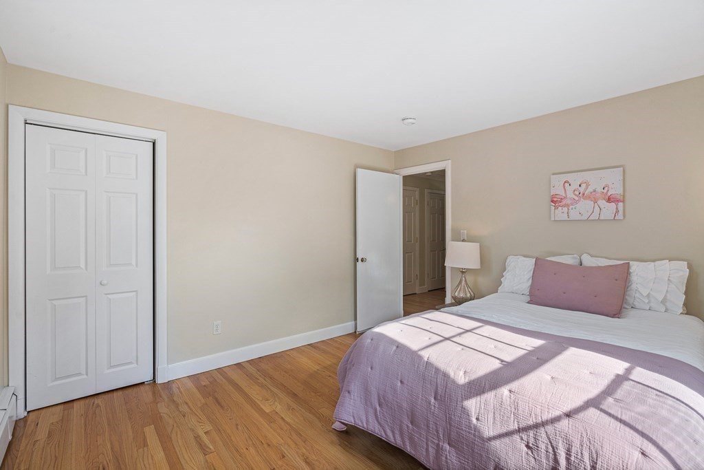 146 Ridge Street Winchester, MA 01890 - Photo 24 of 40 a bedroom with a bed and wooden floor