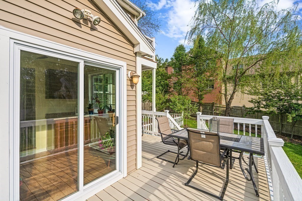 146 Ridge Street Winchester, MA 01890 - Photo 32 of 40 a view of a patio with table and chairs and wooden floor