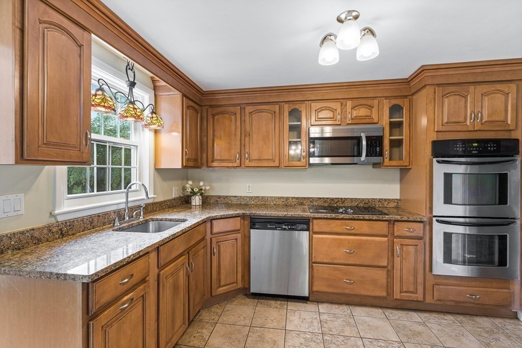 146 Ridge Street Winchester, MA 01890 - Photo 7 of 40 a kitchen with stainless steel appliances granite countertop a sink and dishwasher a stove top oven with wooden floor