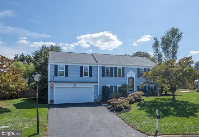 an aerial view of a house with garden space and street view
