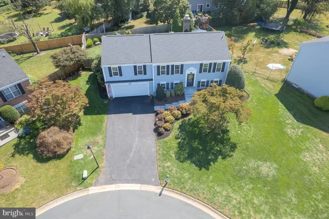 a view of a hallway with wooden floor and entryway