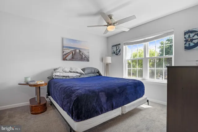 a bathroom with a granite countertop toilet sink and mirror