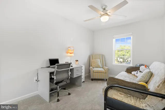 a view of a wooden deck with chairs and a small yard