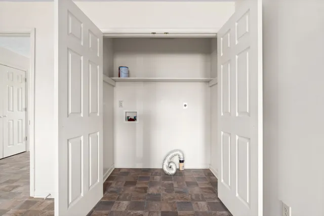 an empty room with fan and windows