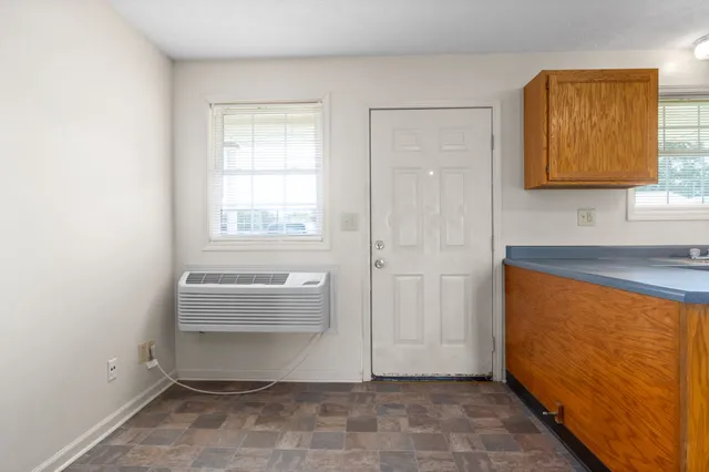 a view of room with window and bathroom