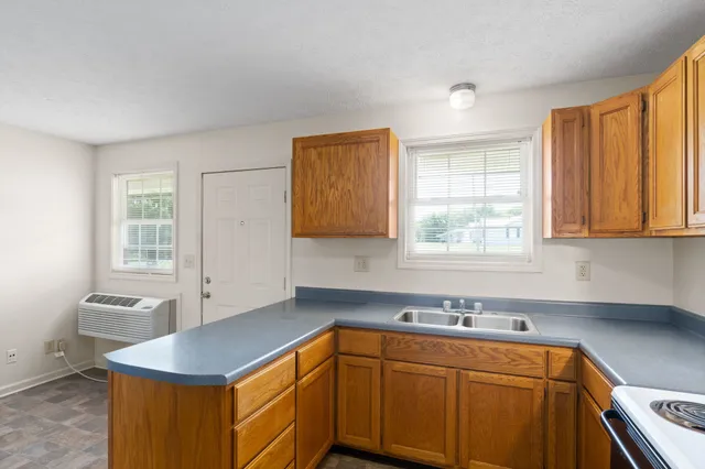 a kitchen with stainless steel appliances granite countertop a sink stove and cabinets