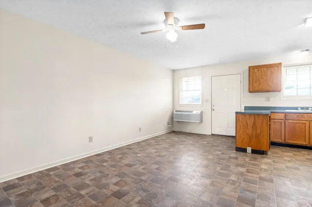a view of a livingroom with wooden floor and a cabinet