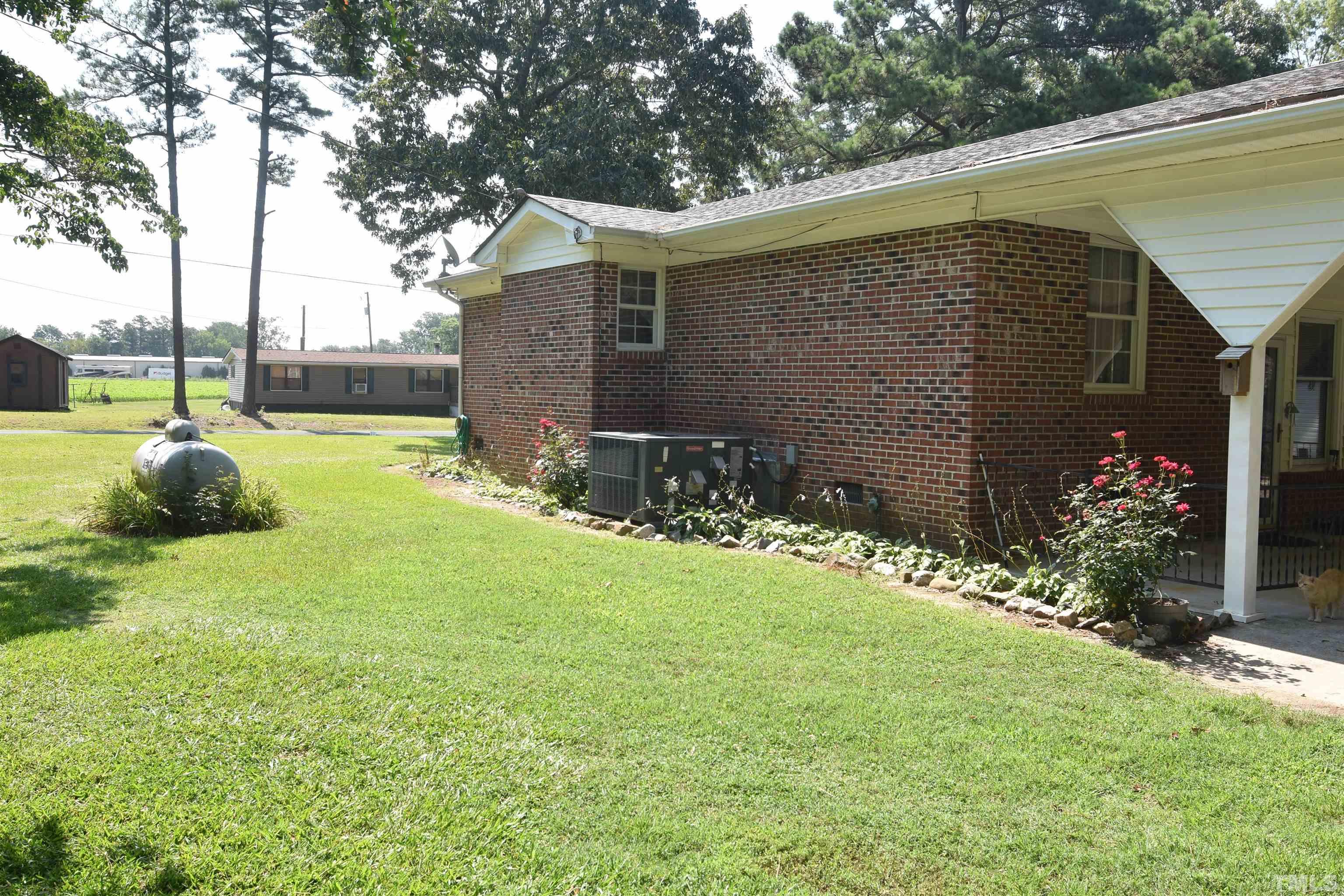 1226 Weeks Road Dunn, NC 28334 - Photo 11 of 43 a backyard of a house with lots of green space