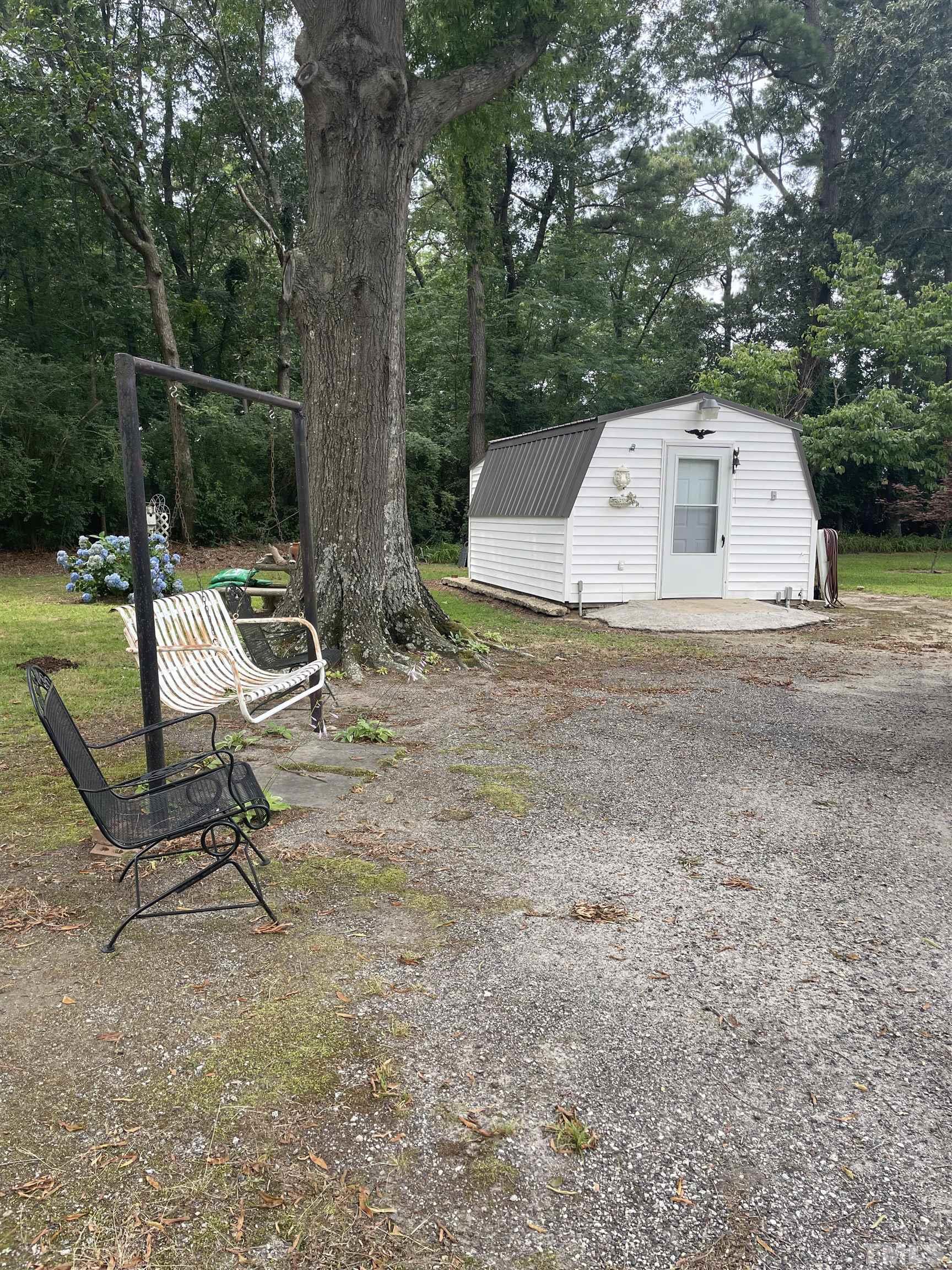 1226 Weeks Road Dunn, NC 28334 - Photo 4 of 43 a view of a backyard with a table and chairs