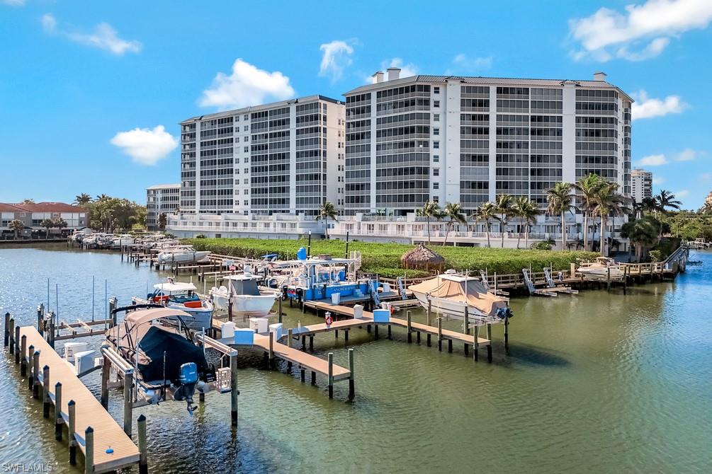 400 Flagship Drive, Unit 908 Naples, FL 34108 - Photo 21 of 27 a view of a lake with outdoor seating