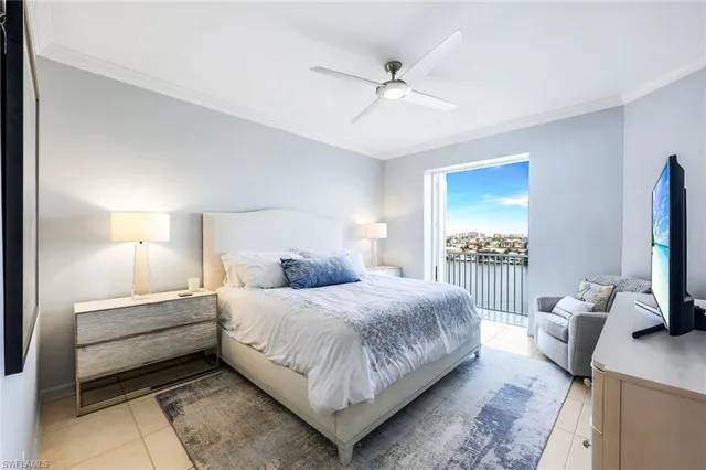 a bedroom with a bed and a flat tv screen on dresser