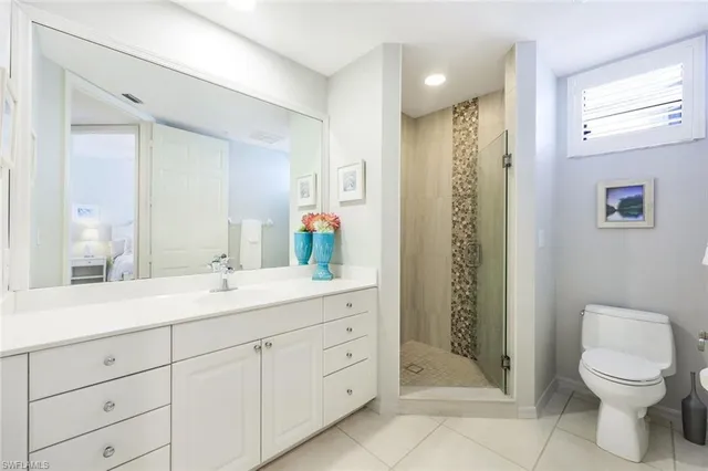 a spacious bathroom with a shower sink and mirror