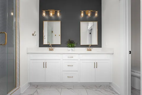 a spacious bathroom with a granite countertop sink mirror and a