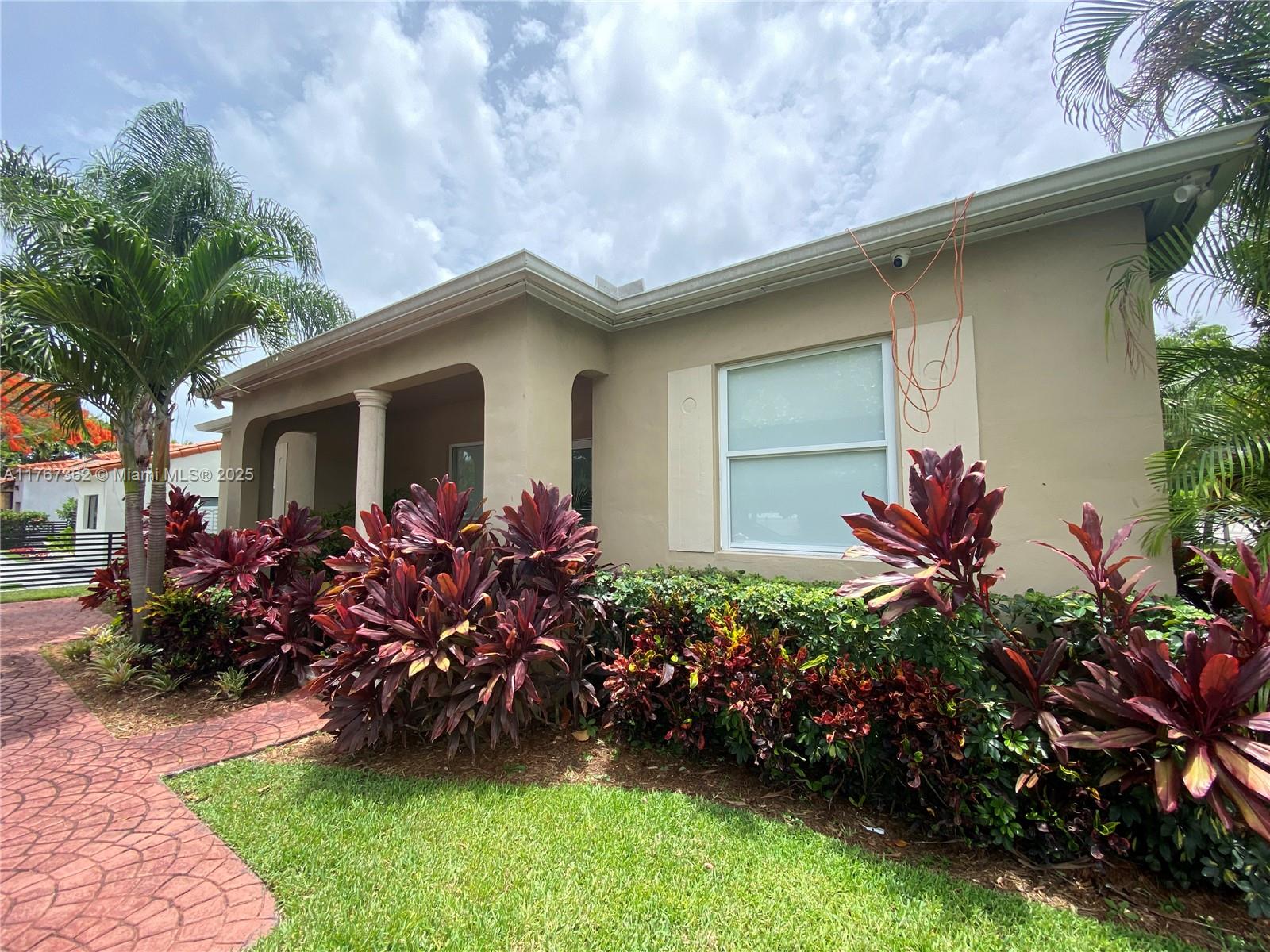 790 Southwest 21st Road Miami, FL 33129 - Photo 2 of 83 a front view of a house with a garden