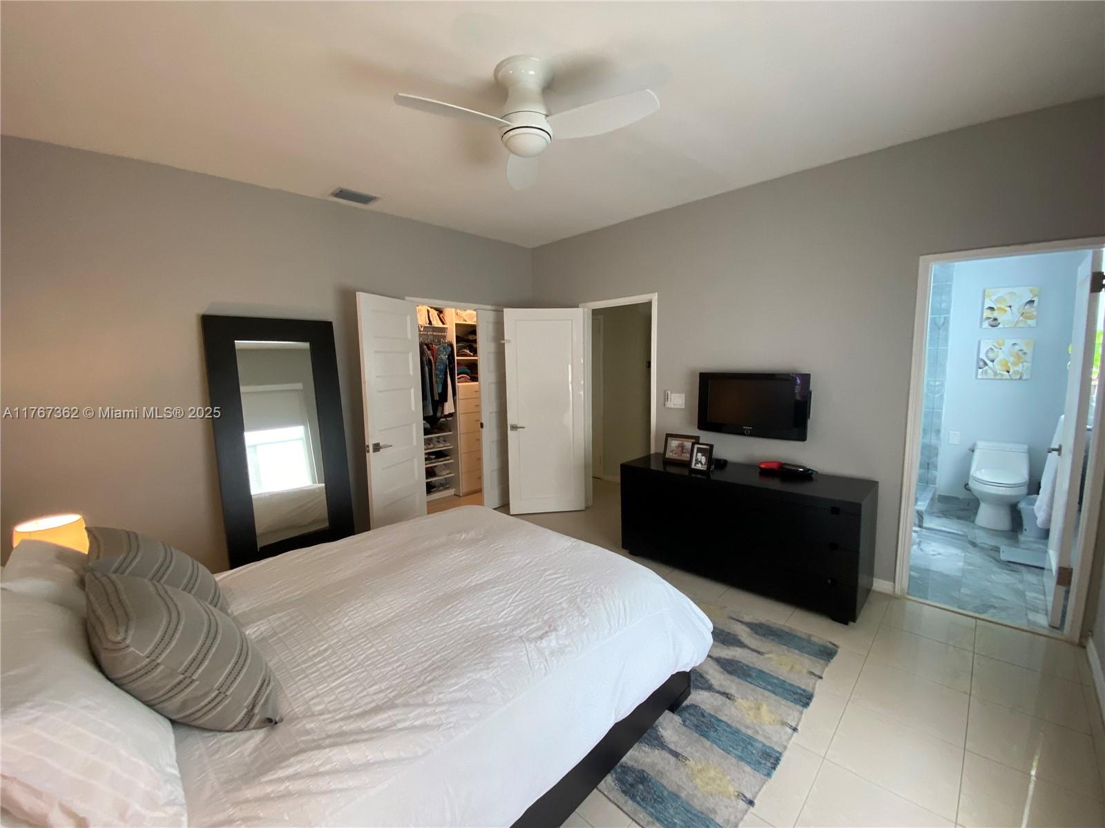 790 Southwest 21st Road Miami, FL 33129 - Photo 40 of 83 a bedroom with a bed and a flat screen tv