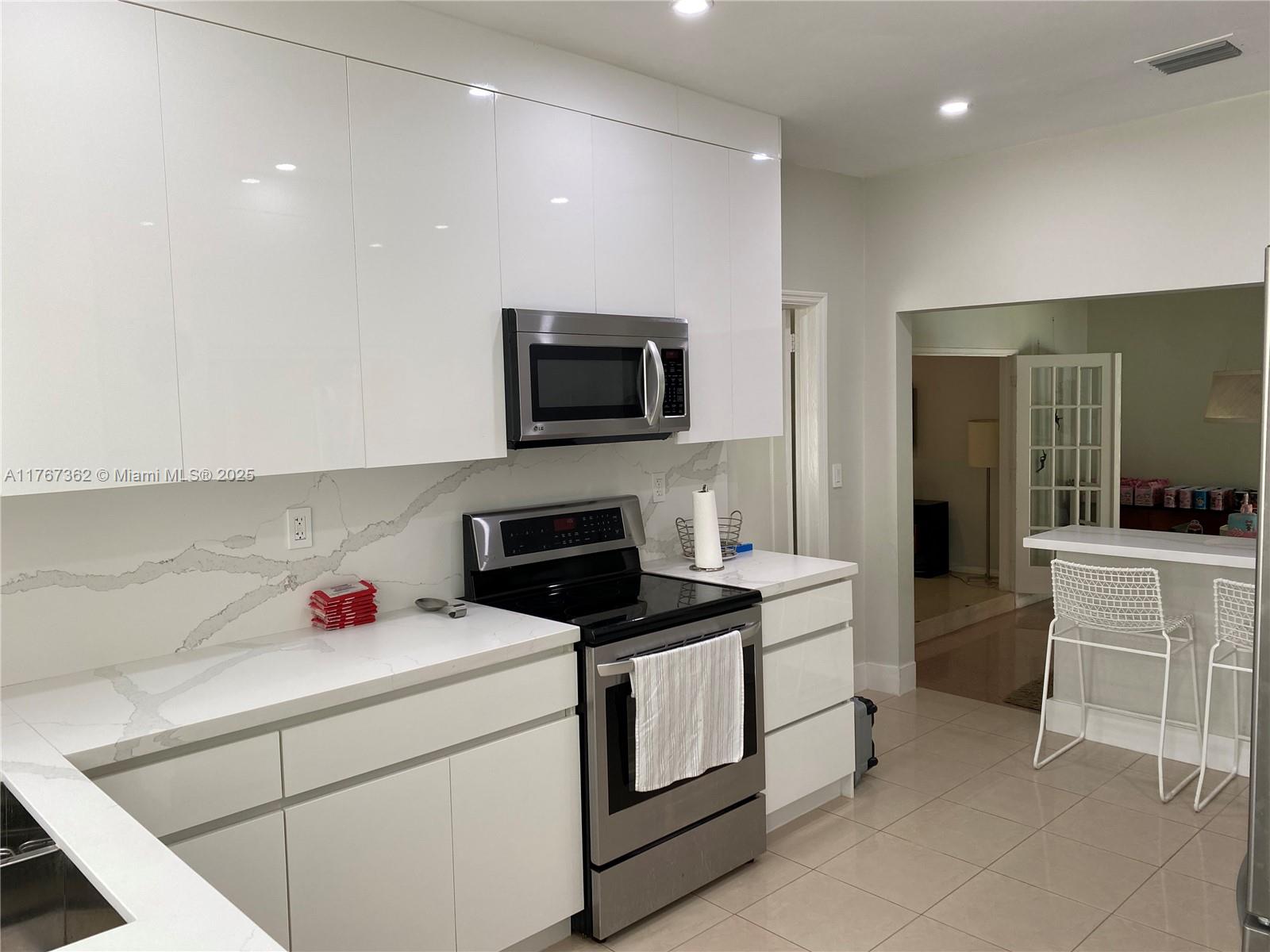 790 Southwest 21st Road Miami, FL 33129 - Photo 4 of 83 a kitchen that has a sink and a stove top oven