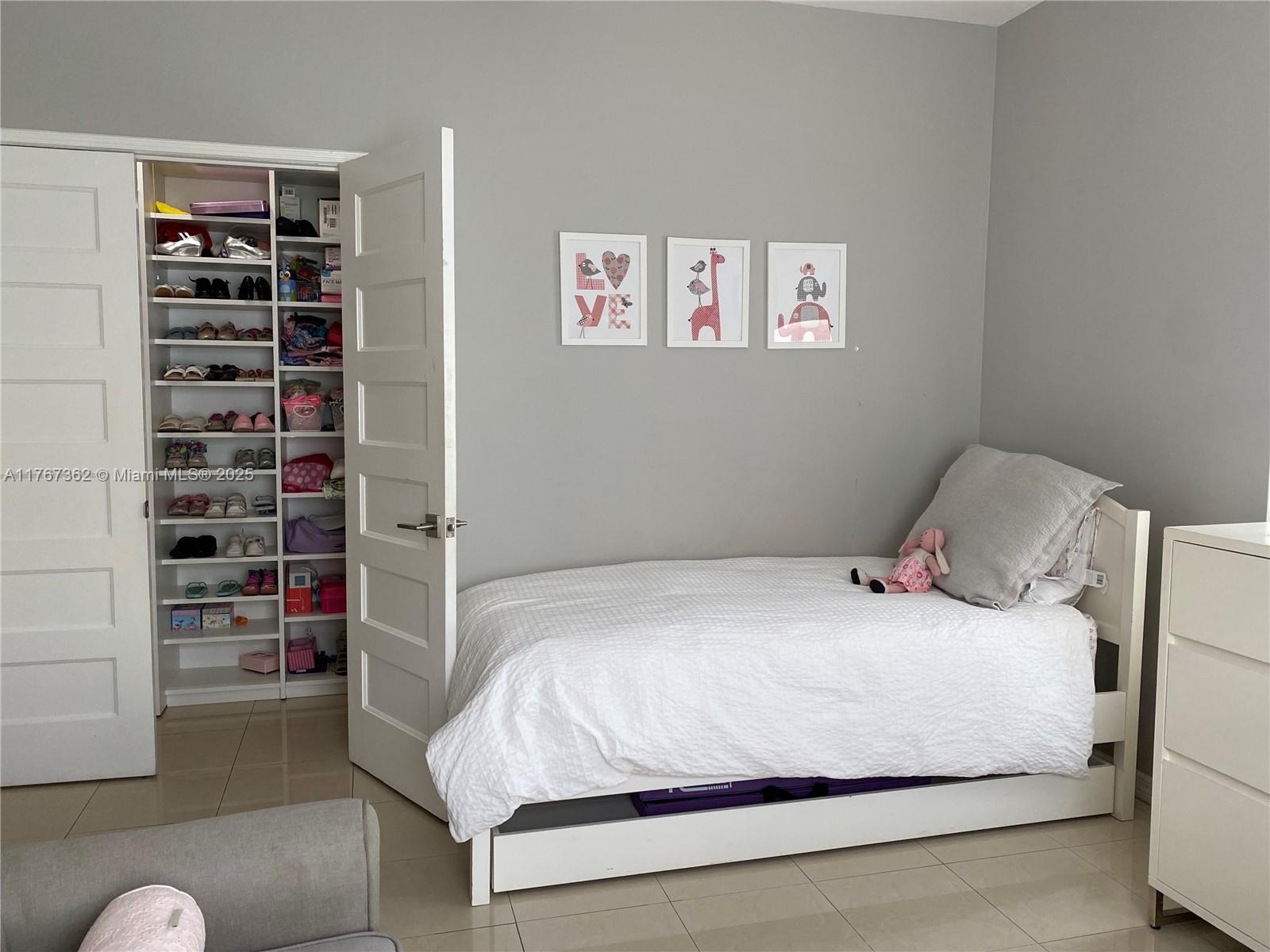 790 Southwest 21st Road Miami, FL 33129 - Photo 50 of 83 a bedroom with a bed and a book shelf