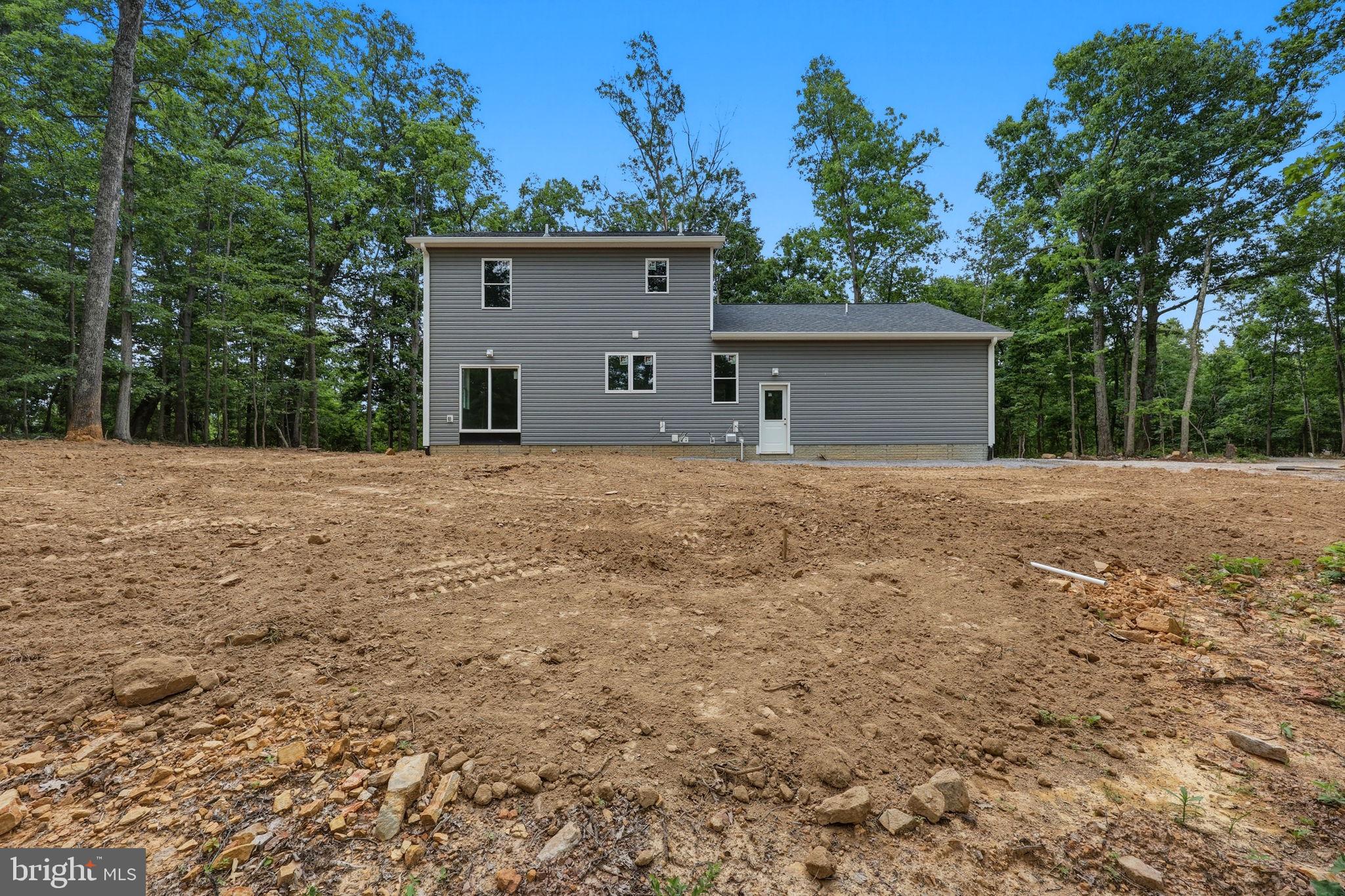 10339 Back Creek Valley Road Hedgesville, WV 25427 - Photo 42 of 48 a front view of house with yard and trees