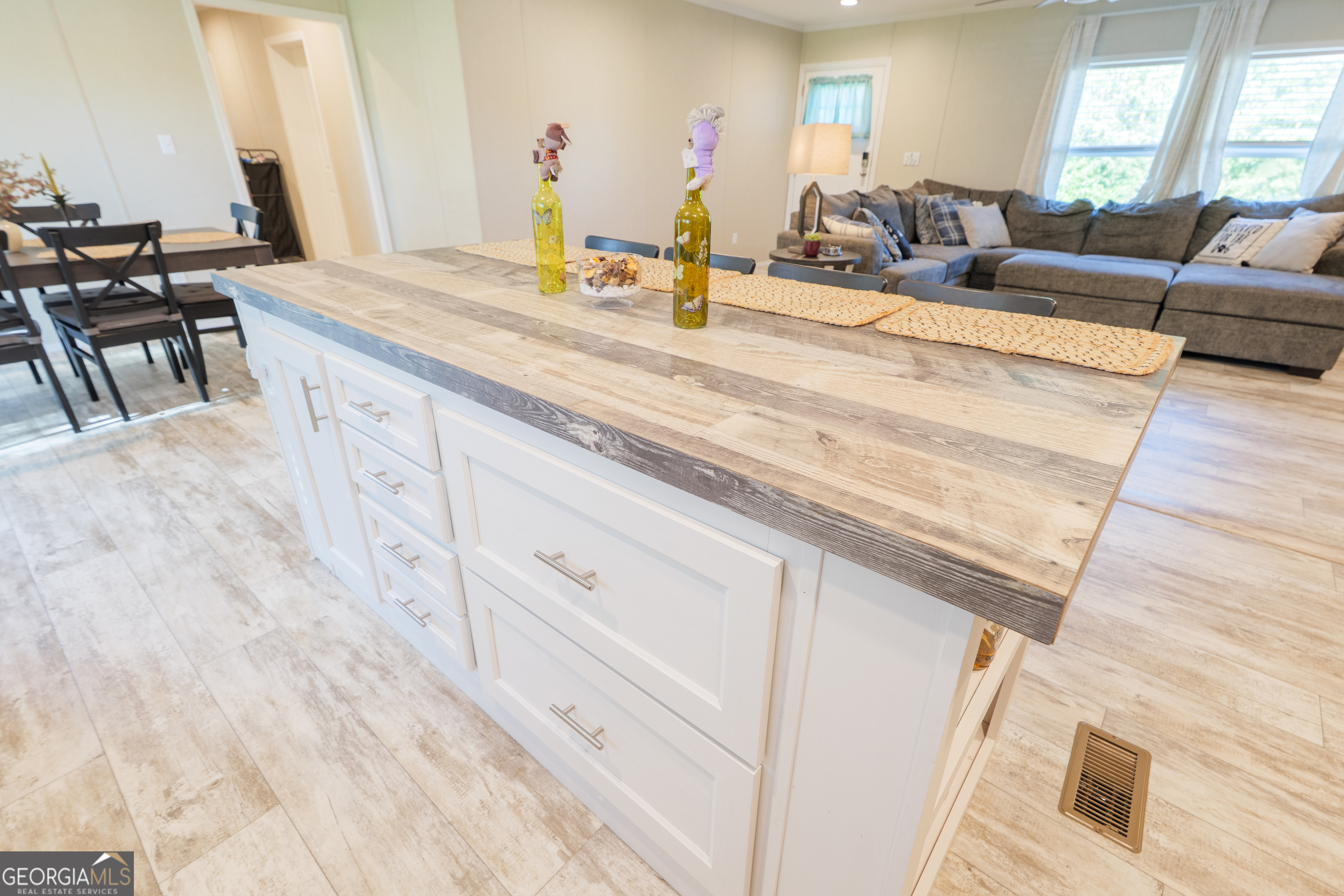 6054 Glenn Road Valdosta, GA 31606 - Photo 13 of 41 a spacious bedroom with a bed a couch and large window