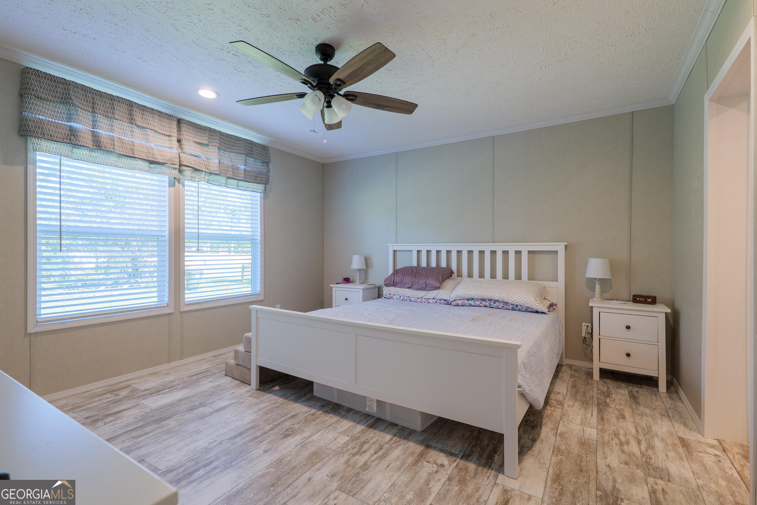 6054 Glenn Road Valdosta, GA 31606 - Photo 15 of 41 a bedroom with a bed and a chandelier
