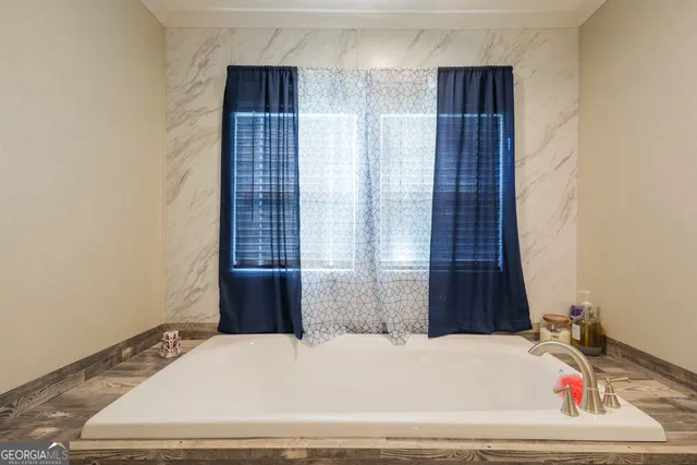 a bathroom with a bathtub and shower