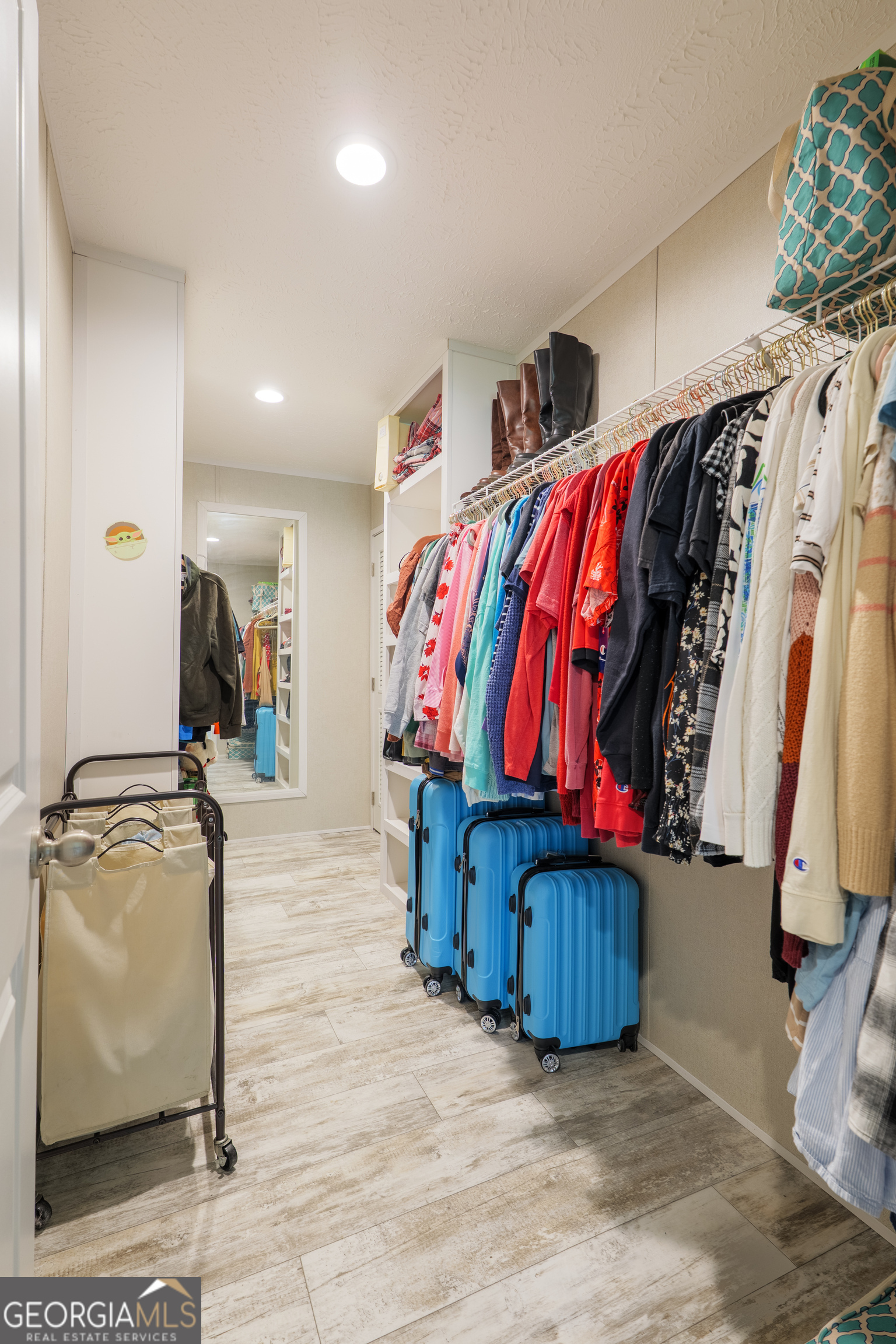 6054 Glenn Road Valdosta, GA 31606 - Photo 23 of 41 a view of walk in closet with clothes and shoes