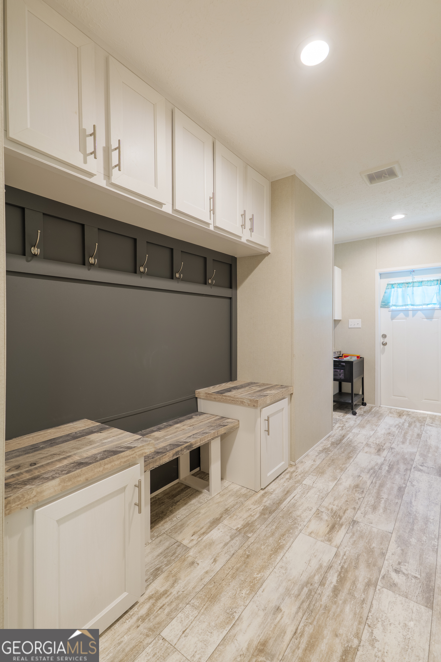 6054 Glenn Road Valdosta, GA 31606 - Photo 27 of 41 a kitchen with stainless steel appliances a stove a refrigerator white cabinets and a refrigerator