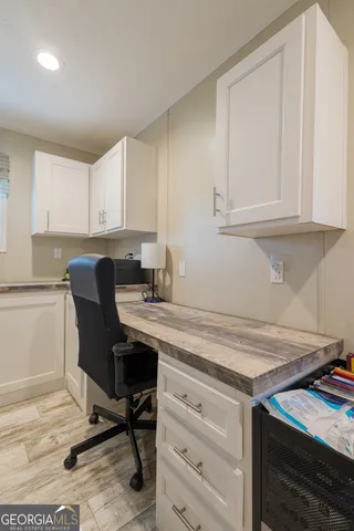 a view of a workspace with furniture