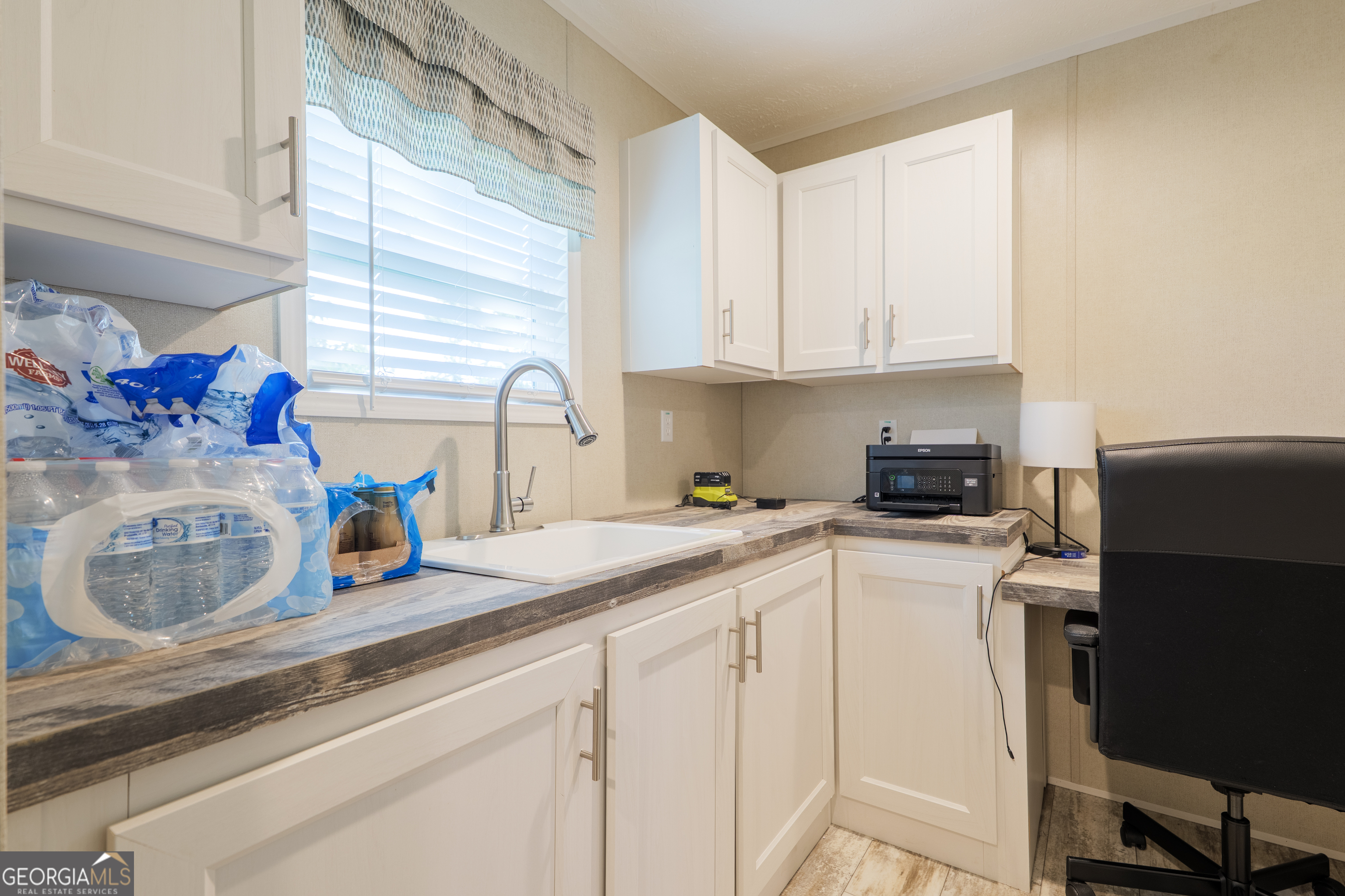 6054 Glenn Road Valdosta, GA 31606 - Photo 30 of 41 a kitchen with a sink cabinets and window