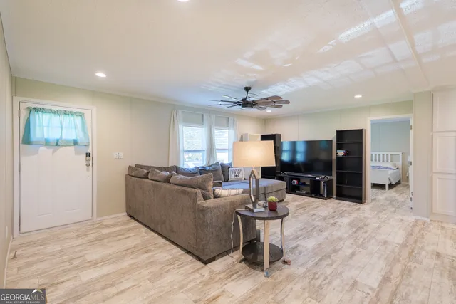 a living room with furniture and a flat screen tv