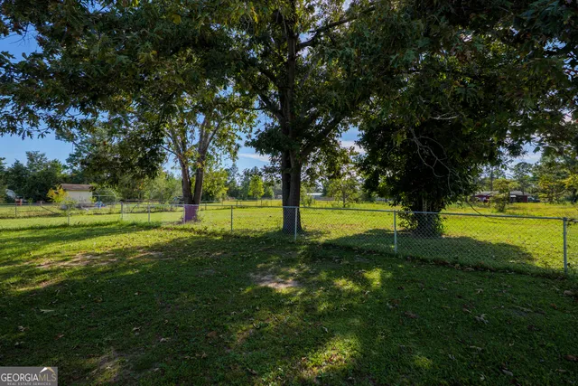 a view of grassy field with trees