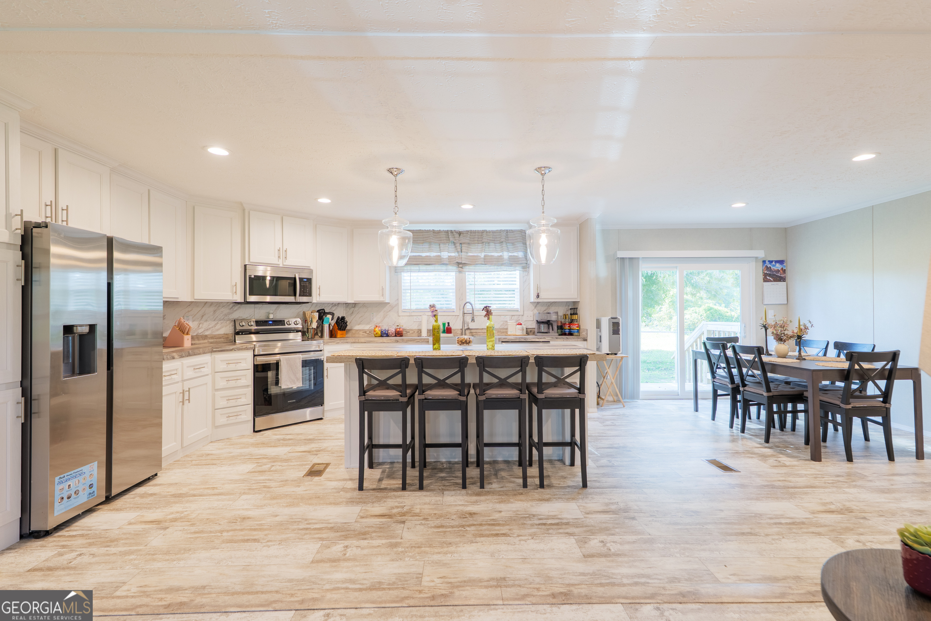6054 Glenn Road Valdosta, GA 31606 - Photo 7 of 41 a view of kitchen with kitchen island dining table and stainless steel appliances