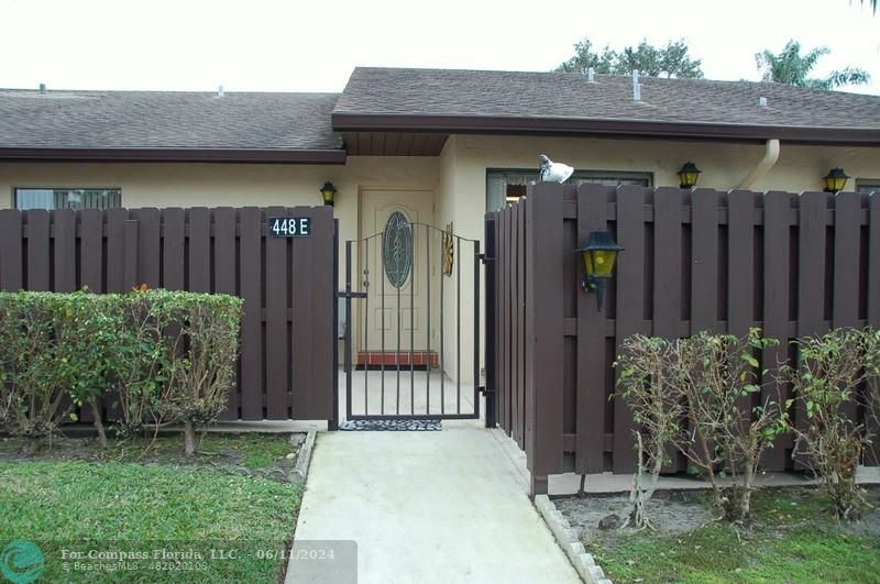 a view of a house with a small yard and plants