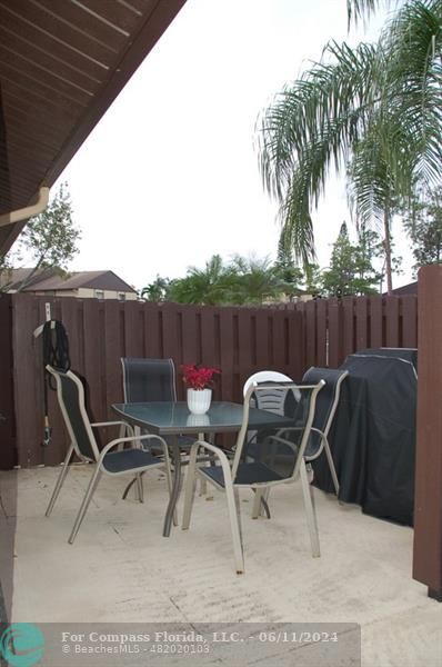 448 Pine Glen Lane, Unit E Greenacres, FL 33463 - Photo 19 of 35 a view of a chairs and table in patio