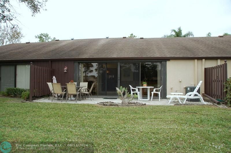 448 Pine Glen Lane, Unit E Greenacres, FL 33463 - Photo 23 of 35 a couple of chairs in front of house