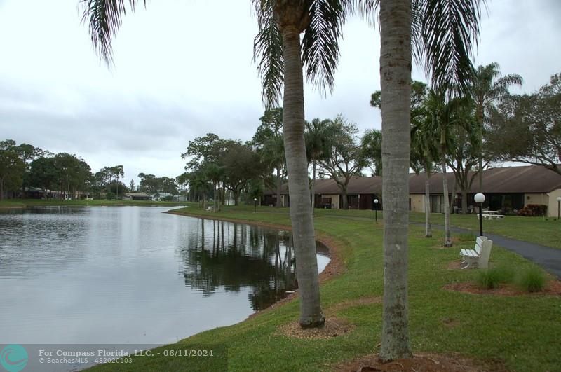 448 Pine Glen Lane, Unit E Greenacres, FL 33463 - Photo 26 of 35 a view of a lake view with a garden