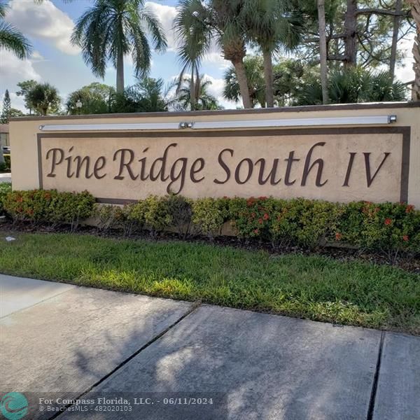 448 Pine Glen Lane, Unit E Greenacres, FL 33463 - Photo 28 of 35 a sign on the side of a building