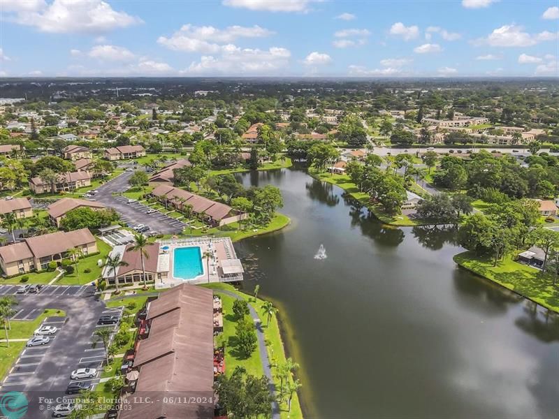 448 Pine Glen Lane, Unit E Greenacres, FL 33463 - Photo 29 of 35 an aerial view of residential houses with outdoor space and lake view