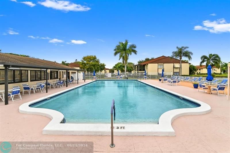 448 Pine Glen Lane, Unit E Greenacres, FL 33463 - Photo 31 of 35 a view of a swimming pool with a deck