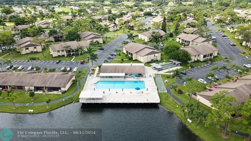 448 Pine Glen Lane, Unit E Greenacres, FL 33463 - Photo 32 of 35 an aerial view of a house with a garden