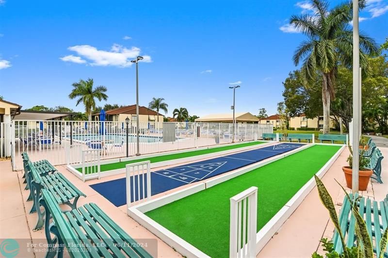 448 Pine Glen Lane, Unit E Greenacres, FL 33463 - Photo 35 of 35 a view of a swimming pool with a deck and a backyard