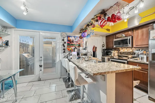 a kitchen with stainless steel appliances granite countertop a sink and cabinets