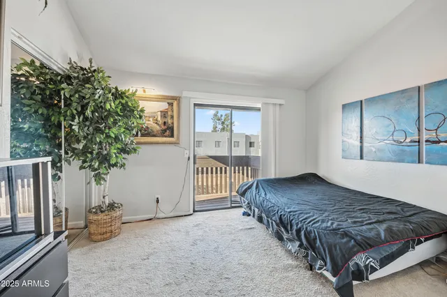 a bedroom with a bed and a potted plant