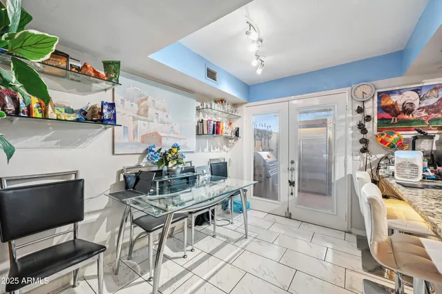 a dining room with furniture and wooden floor